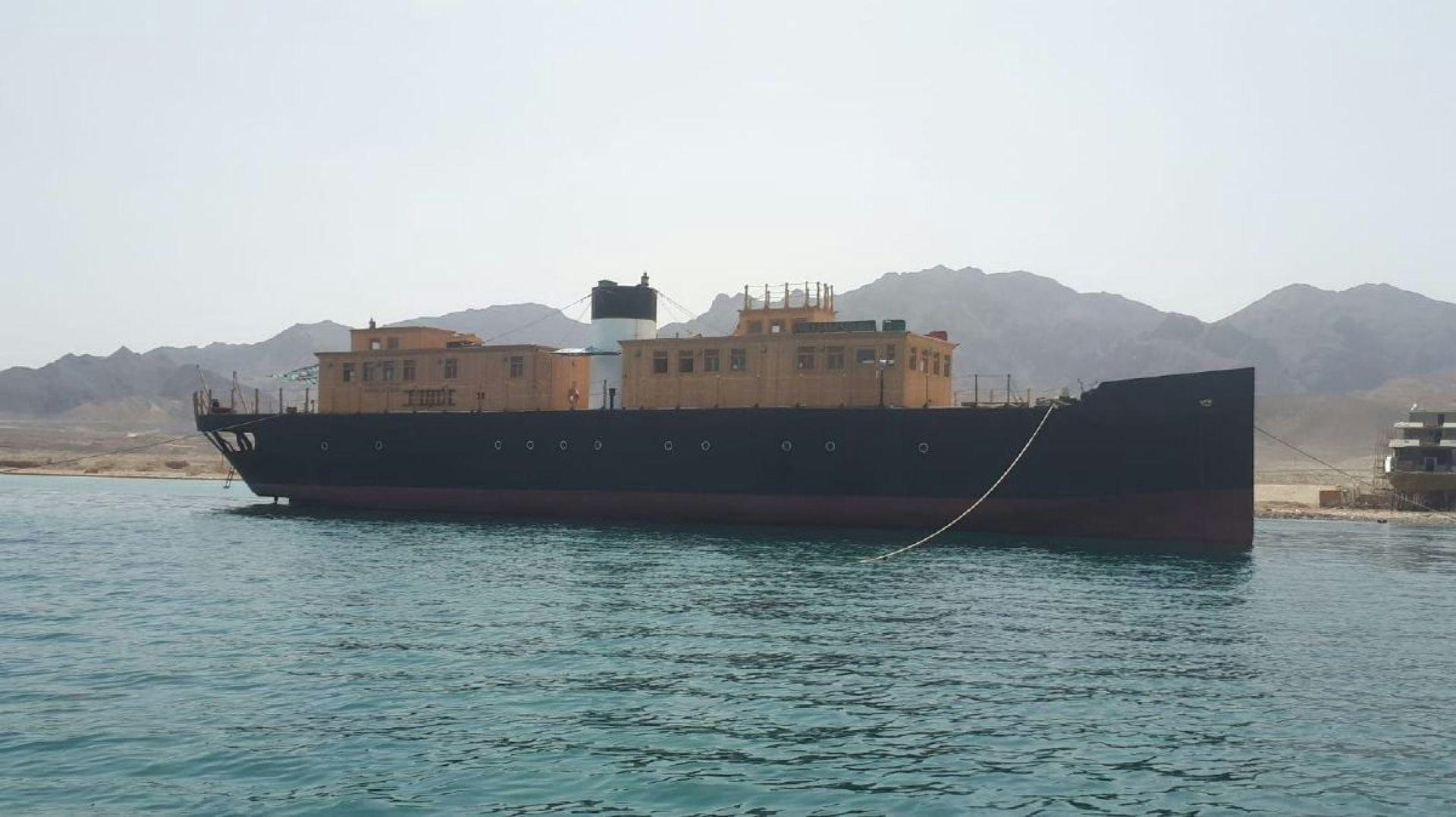 a large ship in the water aboard USS WILLIAMSBURG Yacht for Sale