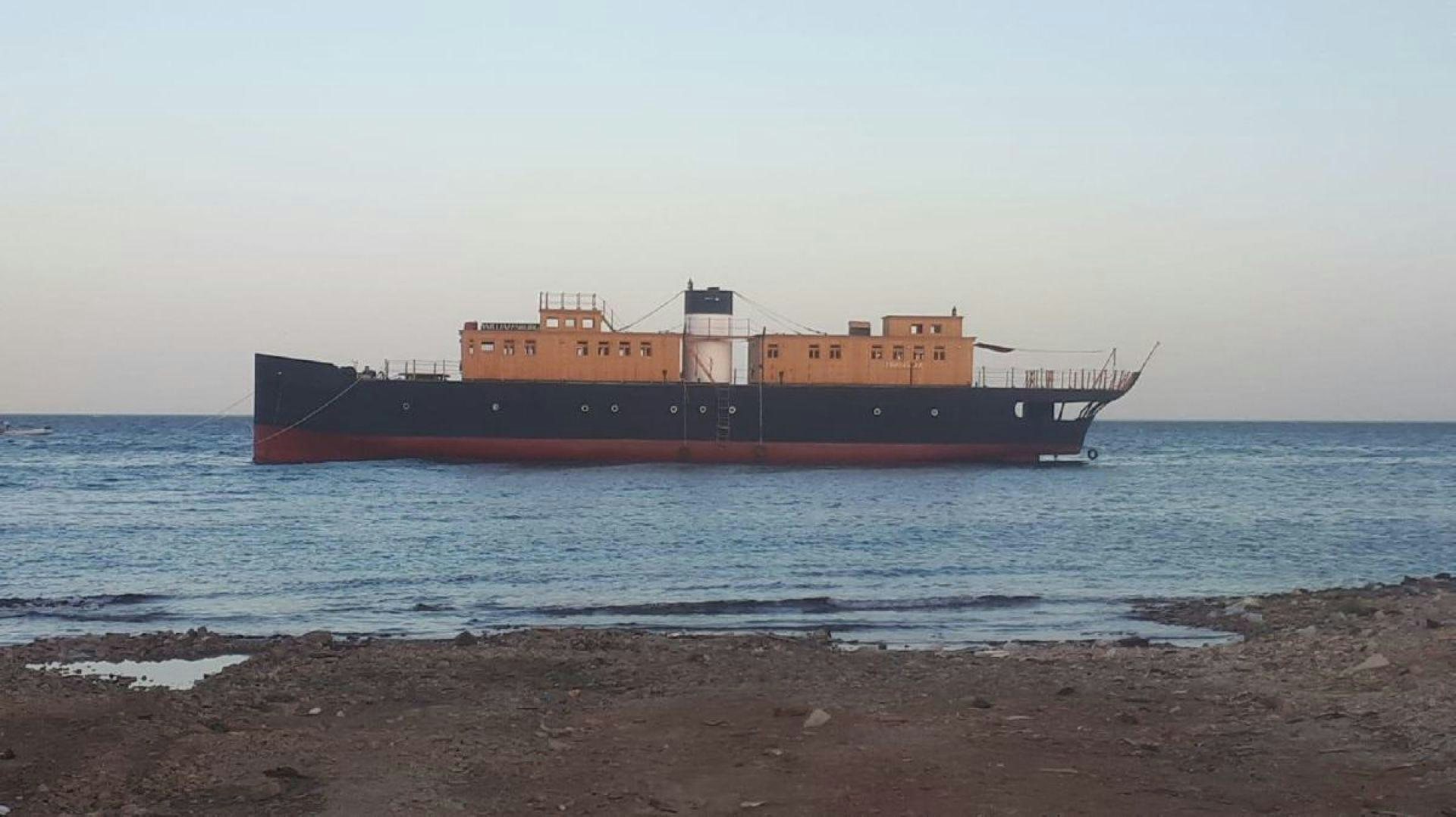 a large ship on the water aboard USS WILLIAMSBURG Yacht for Sale