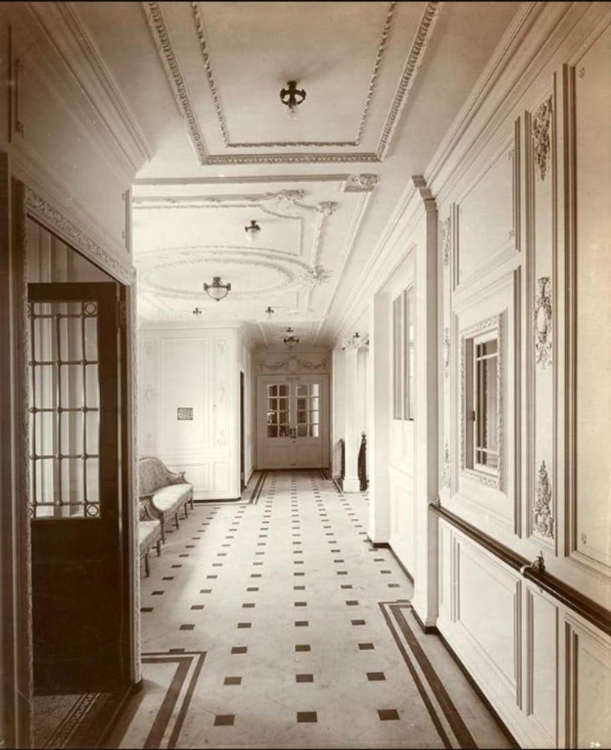 a hallway with a door and chairs aboard USS WILLIAMSBURG Yacht for Sale