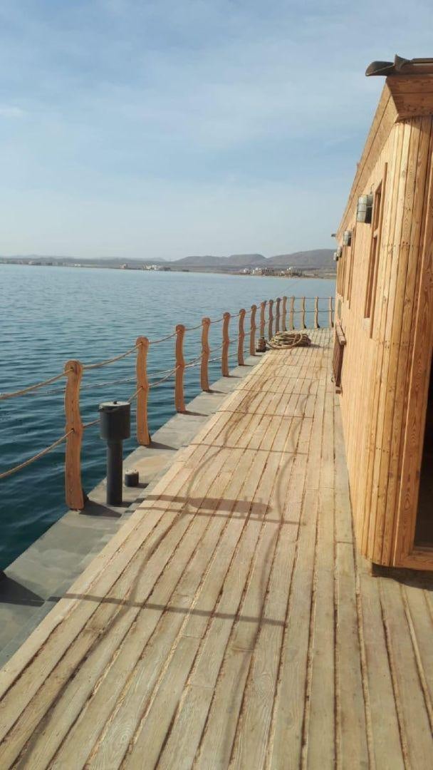 a wooden dock over water aboard USS WILLIAMSBURG Yacht for Sale