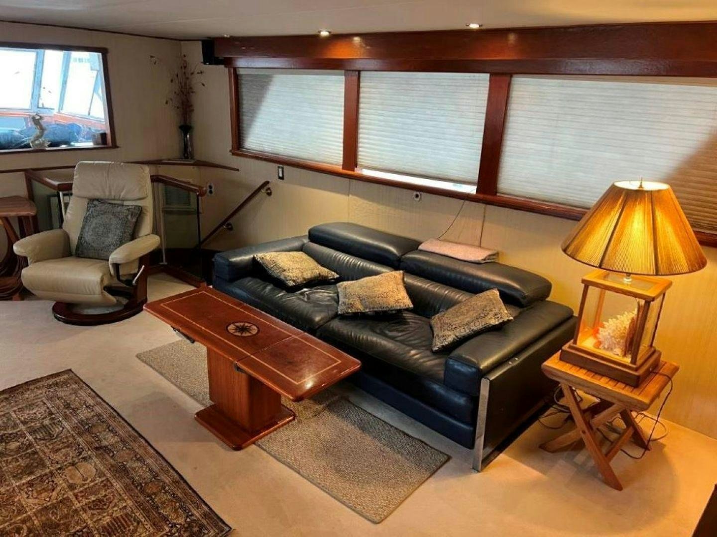 a living room with a leather couch aboard AQUILA JOVIS Yacht for Sale