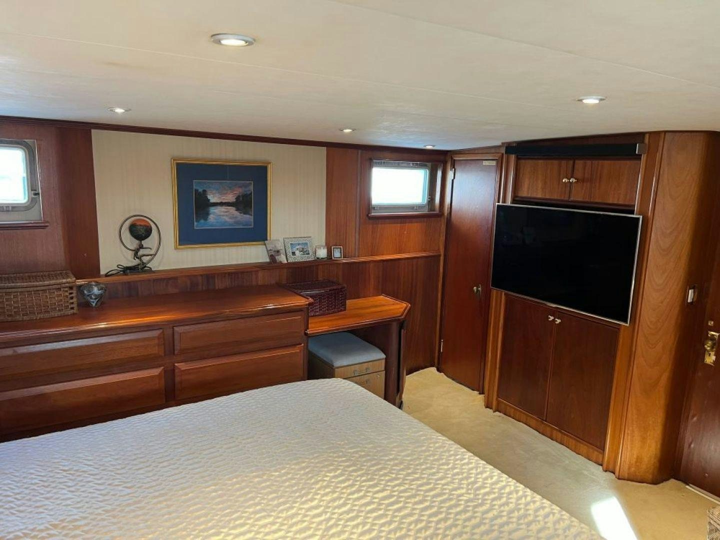 a room with a bed and a television aboard AQUILA JOVIS Yacht for Sale