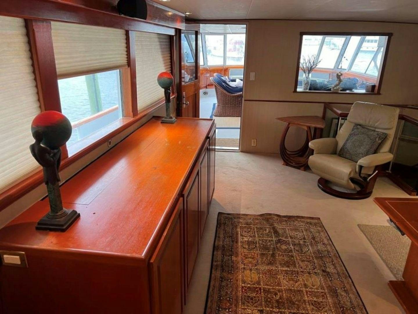 a living room with a table and chairs aboard AQUILA JOVIS Yacht for Sale