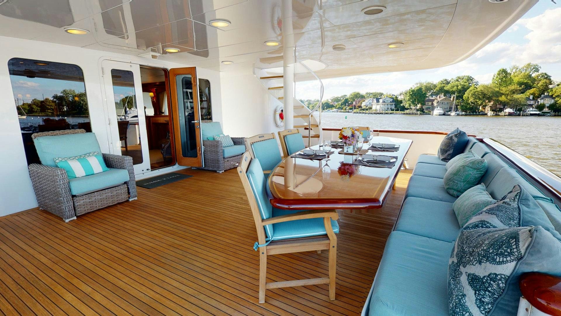a living room with a couch and a table aboard SUMMER LOVE Yacht for Sale