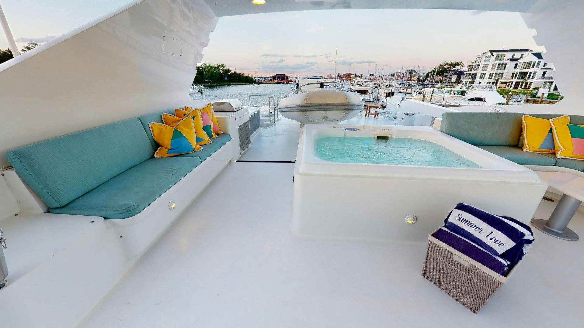 a pool with a lounge chair and a building in the background aboard SUMMER LOVE Yacht for Sale