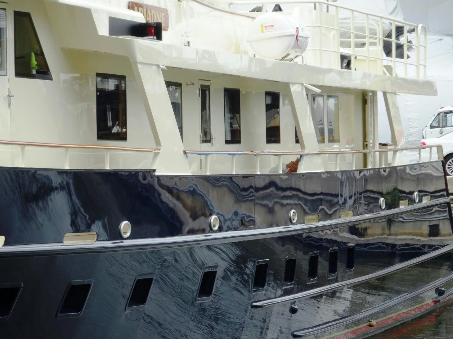 a large white boat with a large ship in the water aboard ARIADNE Yacht for Sale