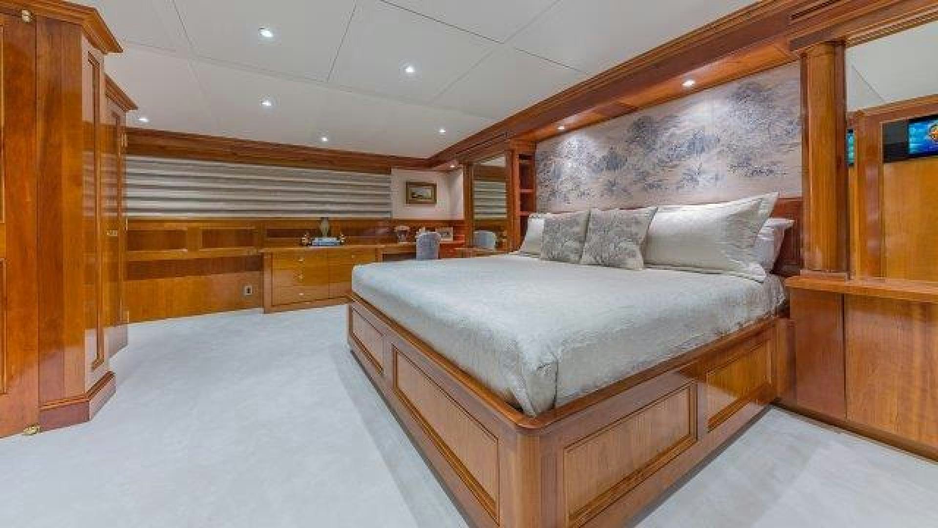 a room with a bed and a wood wall aboard ARIADNE Yacht for Sale