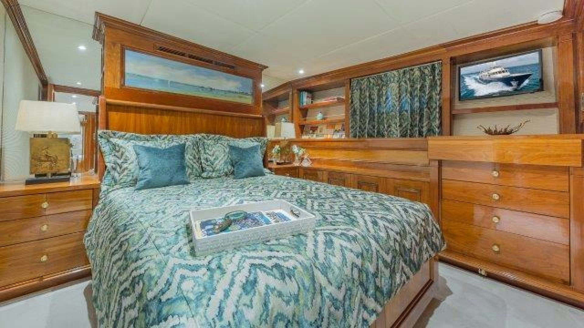 a bed with a blue comforter aboard ARIADNE Yacht for Sale