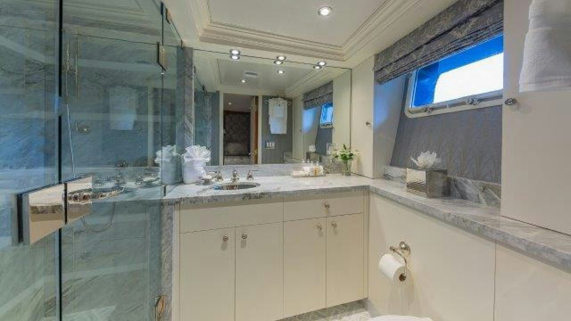 a bathroom with a glass shower aboard ARIADNE Yacht for Sale