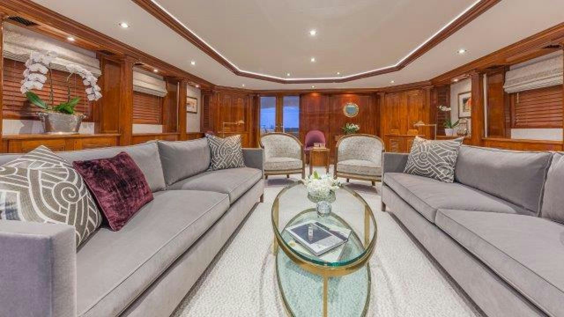 a living room with a couch and a table aboard ARIADNE Yacht for Sale