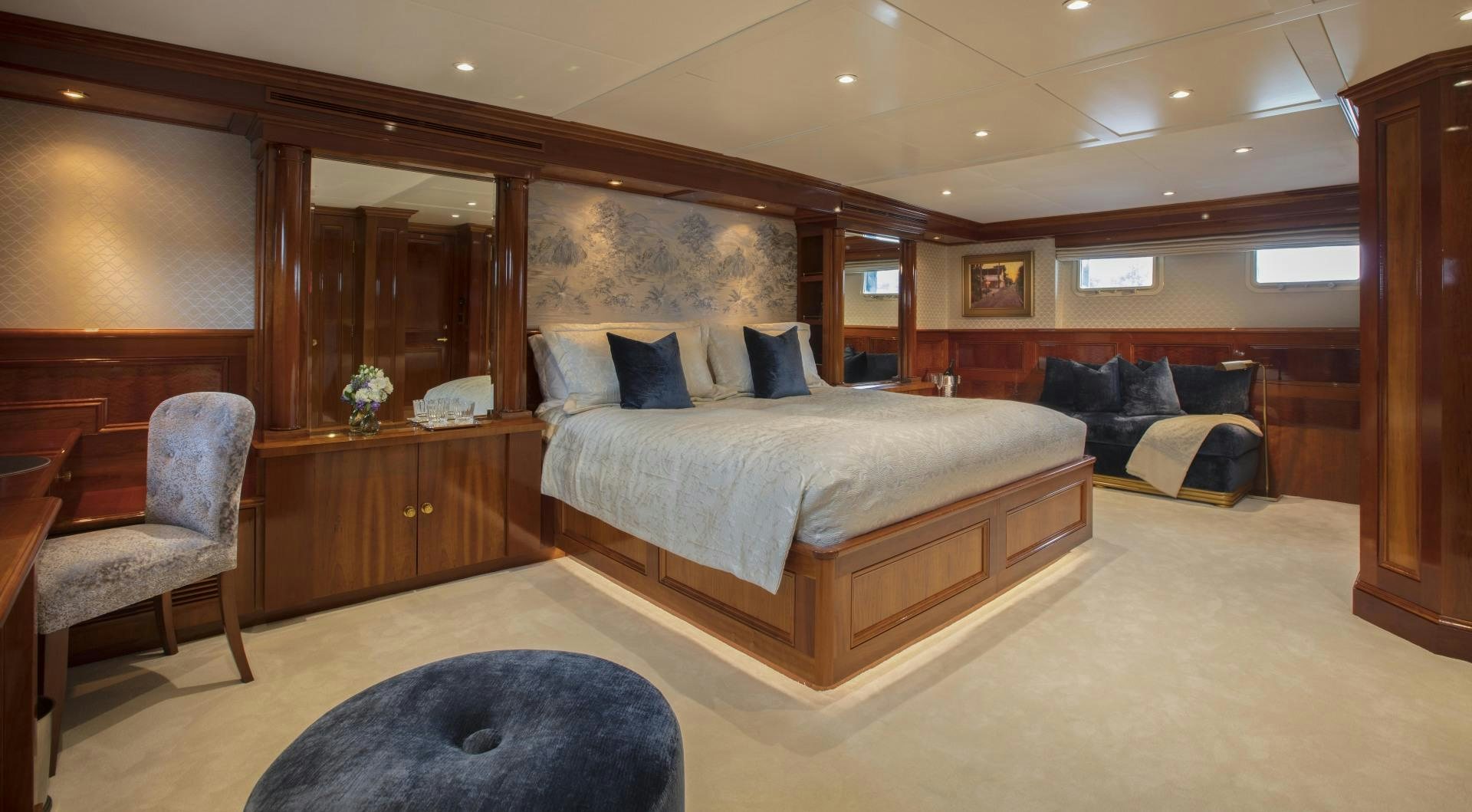 a large bedroom with a bed and a couch aboard ARIADNE Yacht for Sale