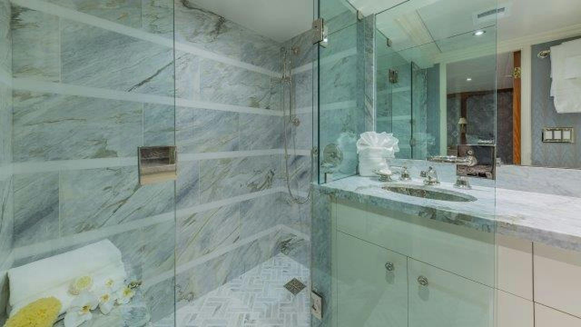 a bathroom with a glass shower aboard ARIADNE Yacht for Sale