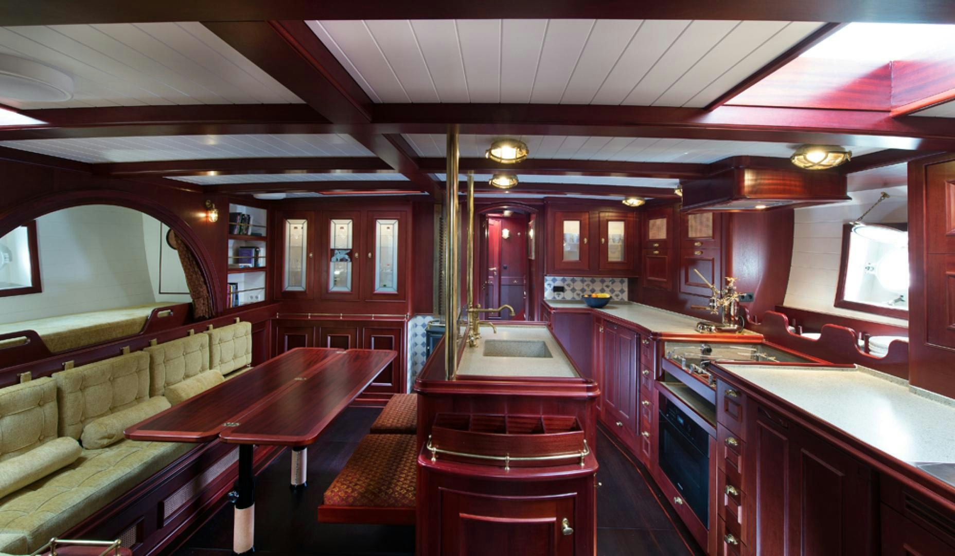 a kitchen with a bar and a table aboard SPIRIT OF VENICE Yacht for Sale