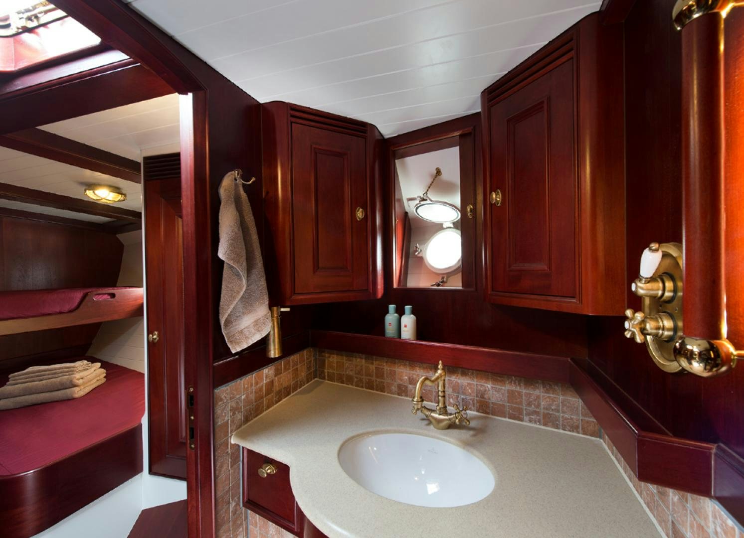a bathroom with a sink and a mirror aboard SPIRIT OF VENICE Yacht for Sale