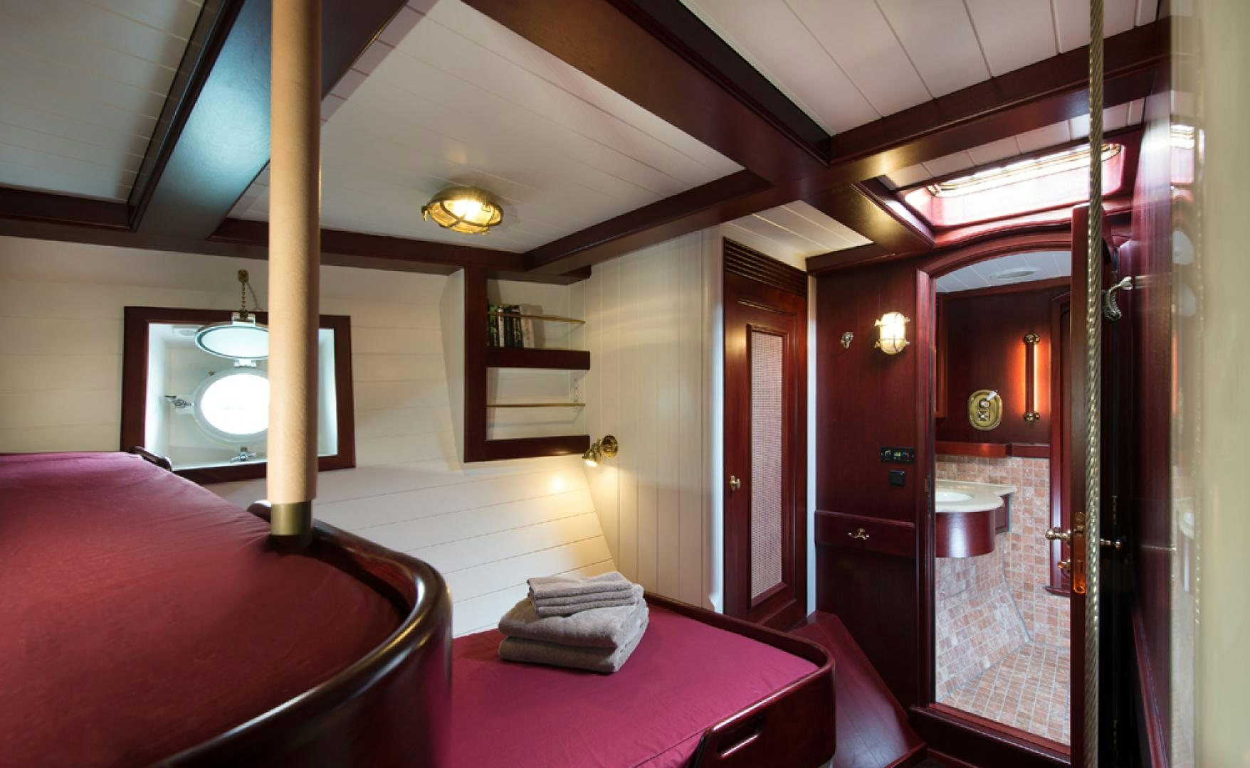 a room with a bed and a fireplace aboard SPIRIT OF VENICE Yacht for Sale