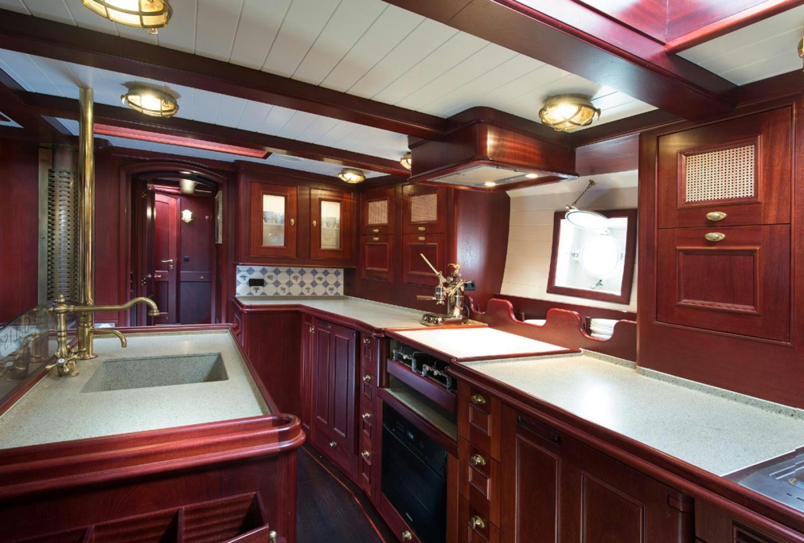 a kitchen with red cabinets aboard SPIRIT OF VENICE Yacht for Sale