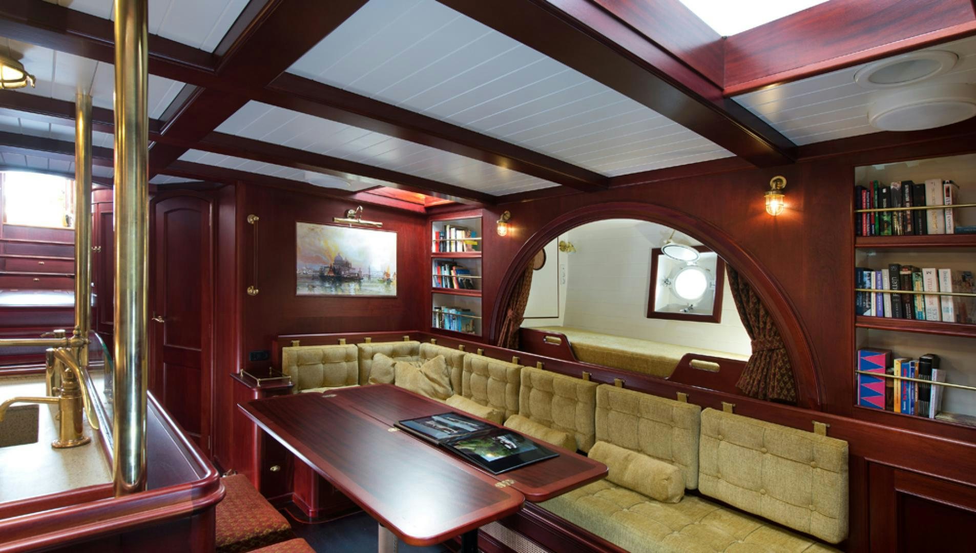 a living room with a couch and a table aboard SPIRIT OF VENICE Yacht for Sale
