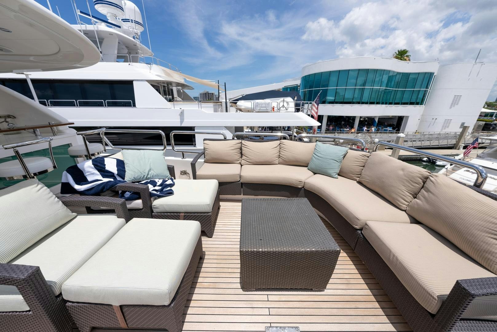 a deck with chairs and a boat aboard ENCORE Yacht for Sale