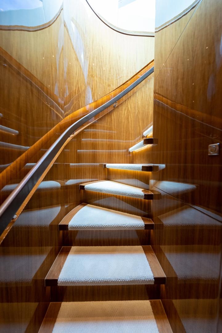 a wooden staircase with a railing aboard ENCORE Yacht for Sale
