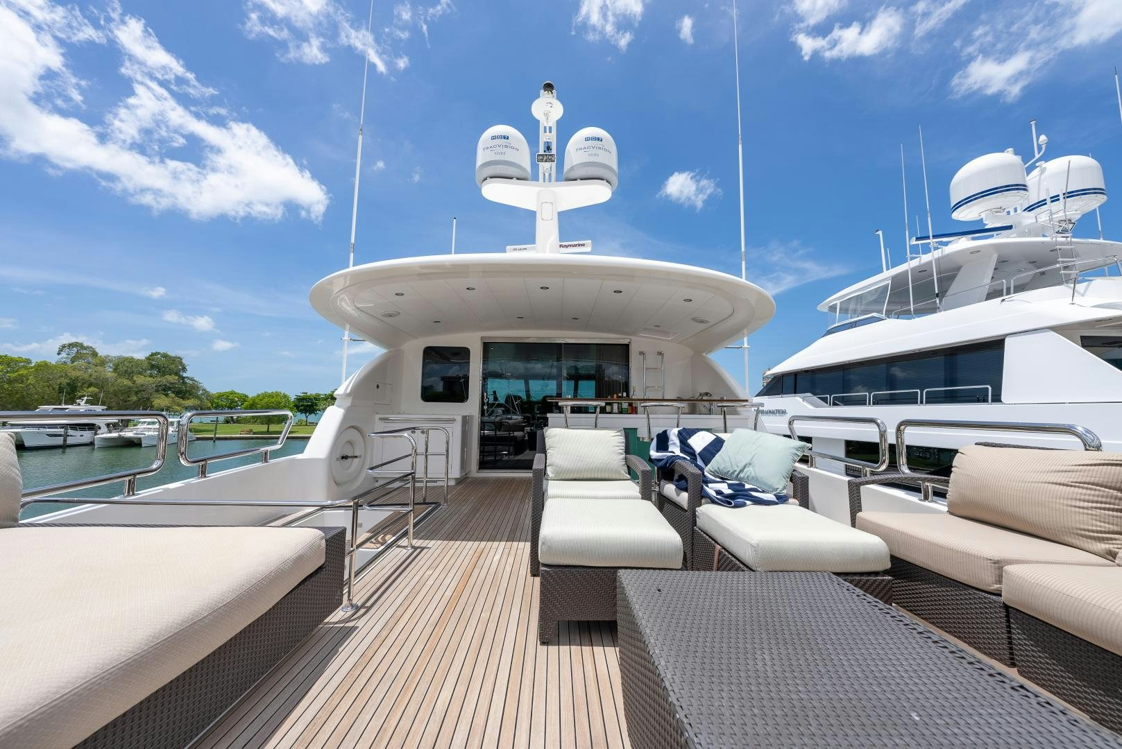 a deck with a boat and chairs on it aboard ENCORE Yacht for Sale