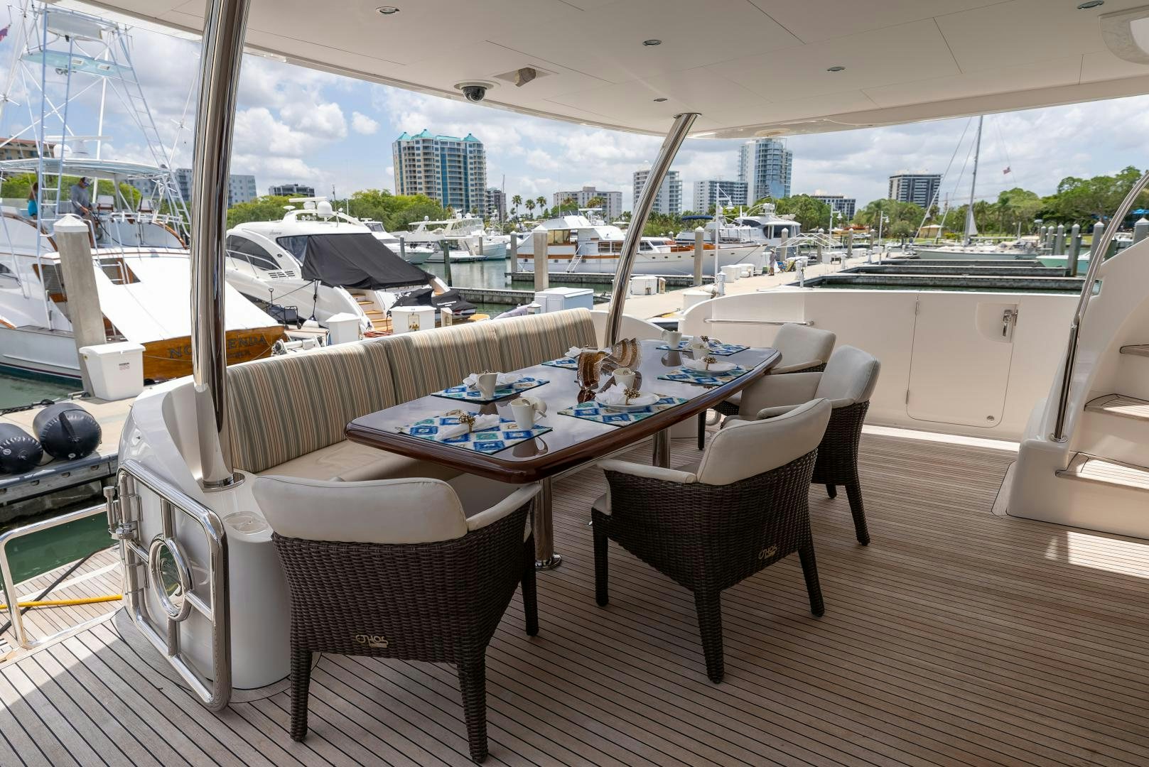 a table and chairs on a deck aboard ENCORE Yacht for Sale