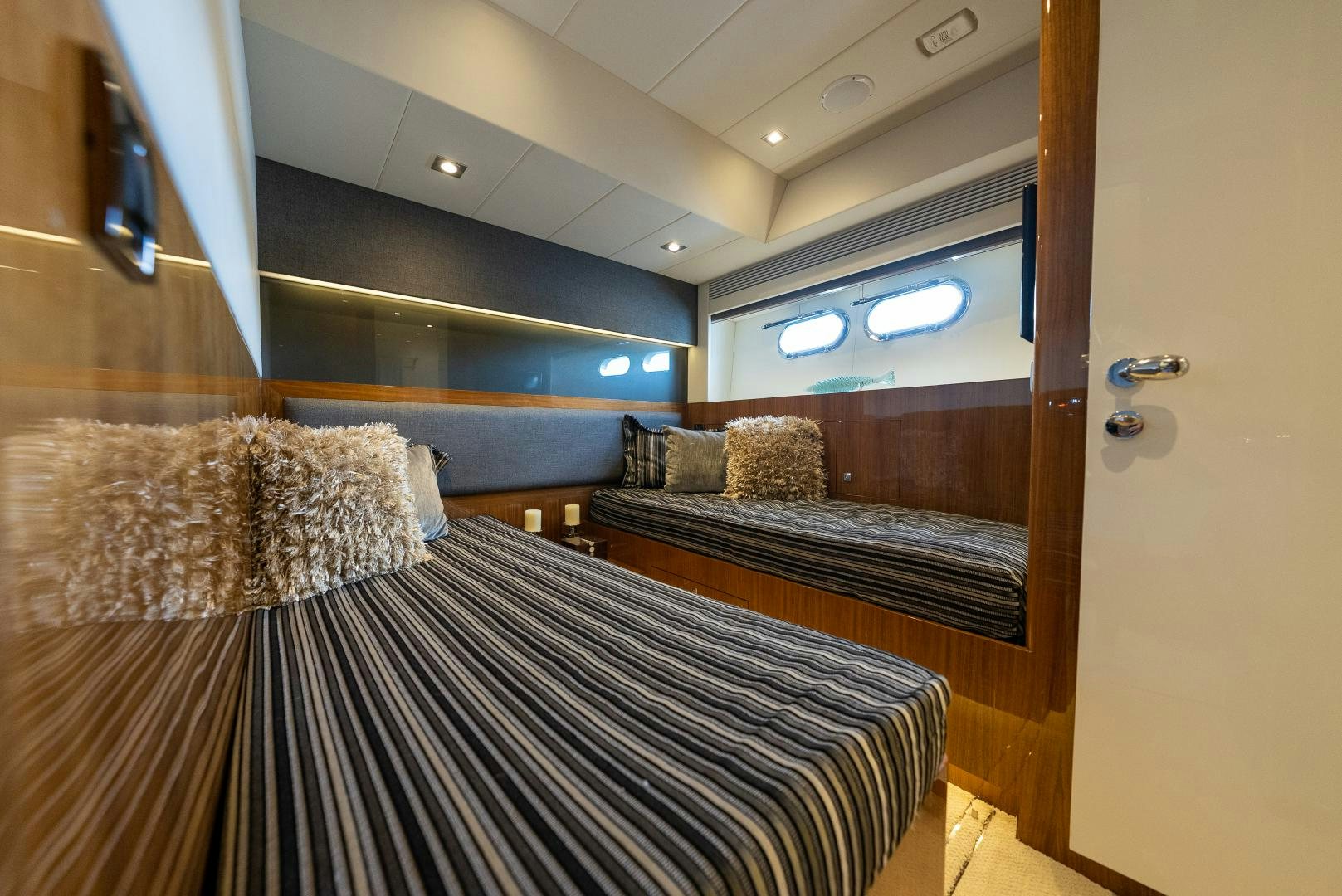 a room with a bed and a couch aboard ENCORE Yacht for Sale