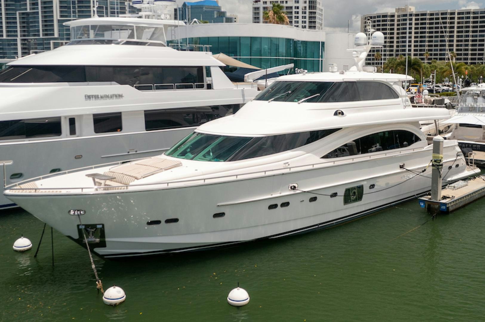 a white yacht in a harbor aboard ENCORE Yacht for Sale