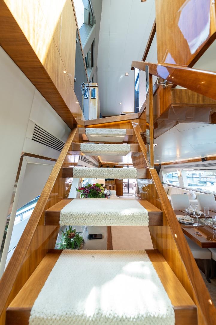 a wooden staircase with a large white floor aboard ENCORE Yacht for Sale