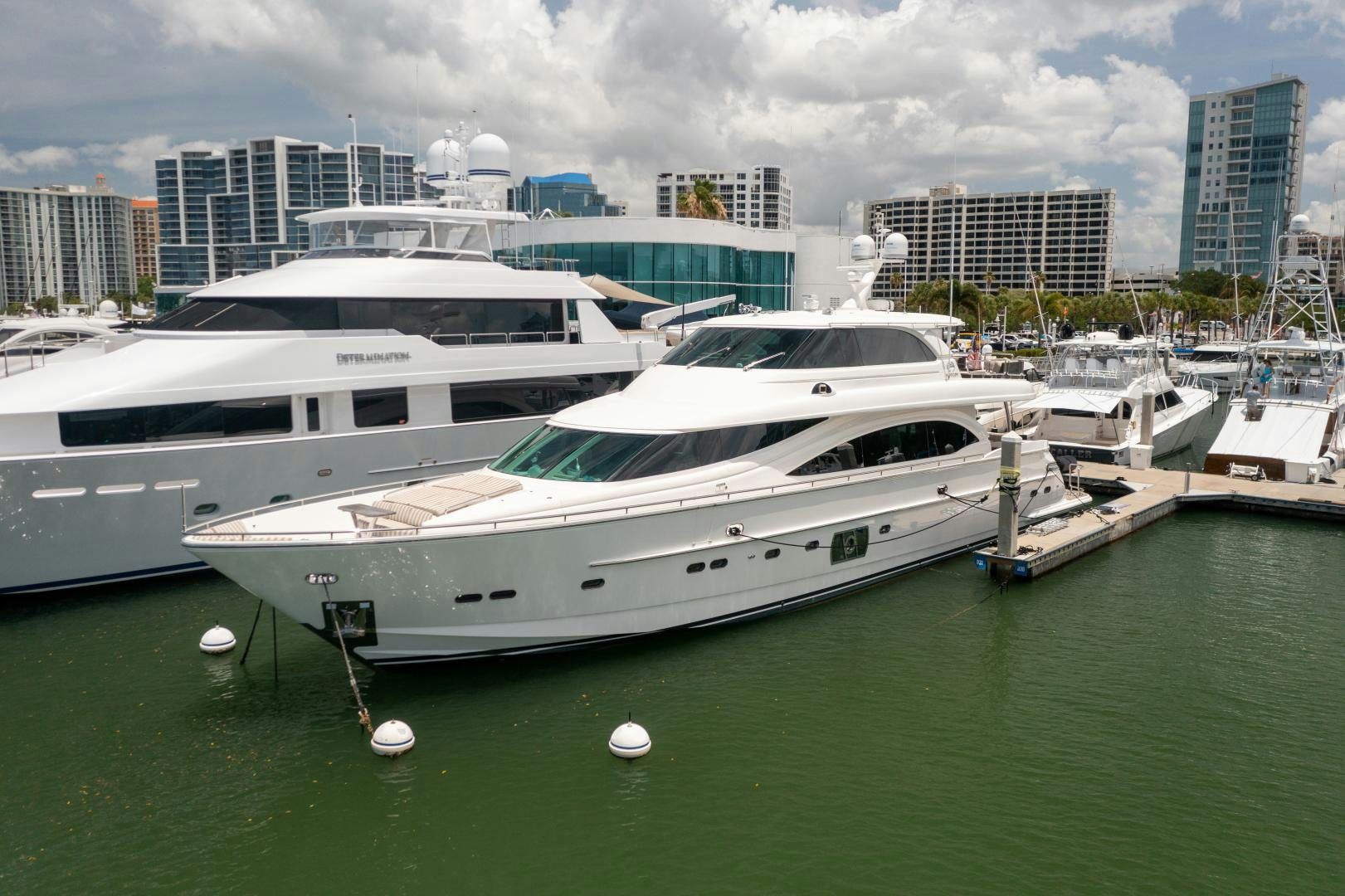 a white yacht in a harbor aboard ENCORE Yacht for Sale