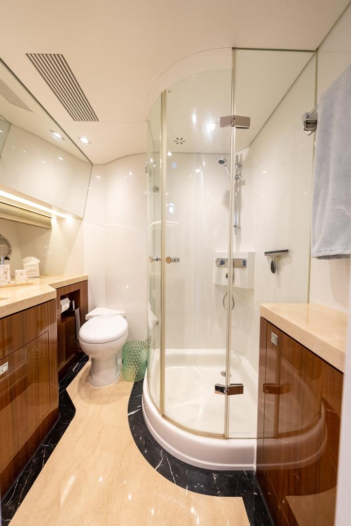 a bathroom with a shower unit and a toilet aboard ENCORE Yacht for Sale