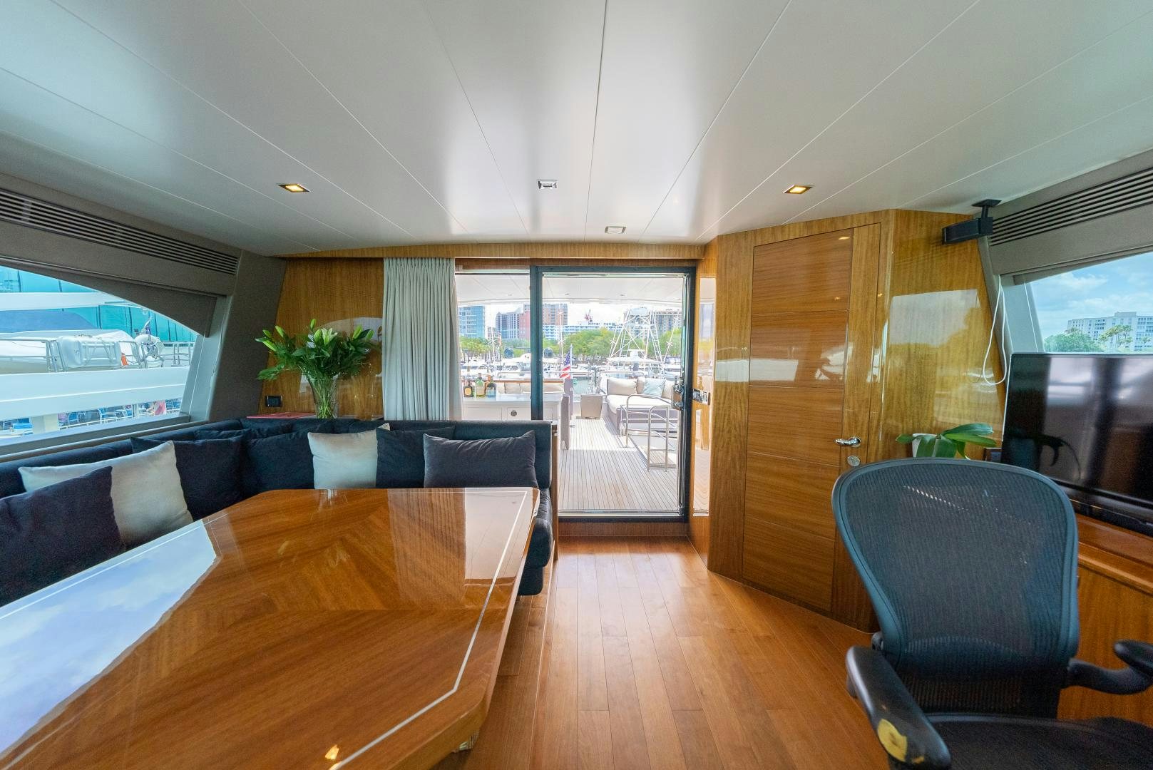 a large living room with a wood floor and a large window aboard ENCORE Yacht for Sale