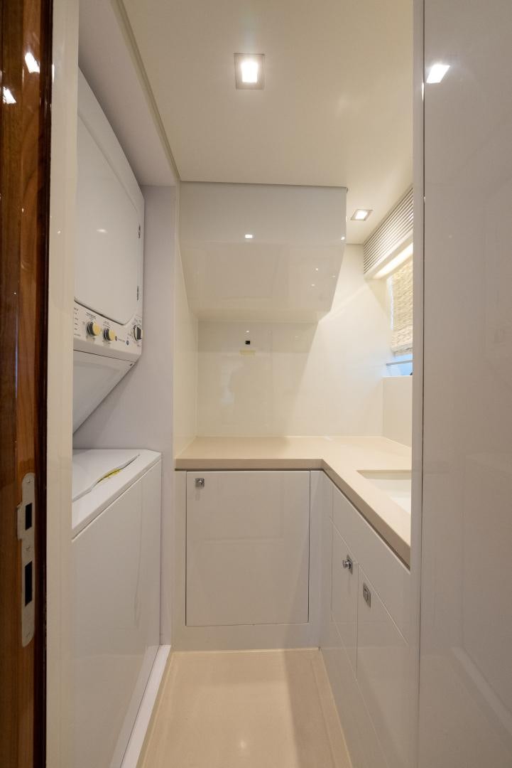 a white kitchen with white cabinets aboard ENCORE Yacht for Sale