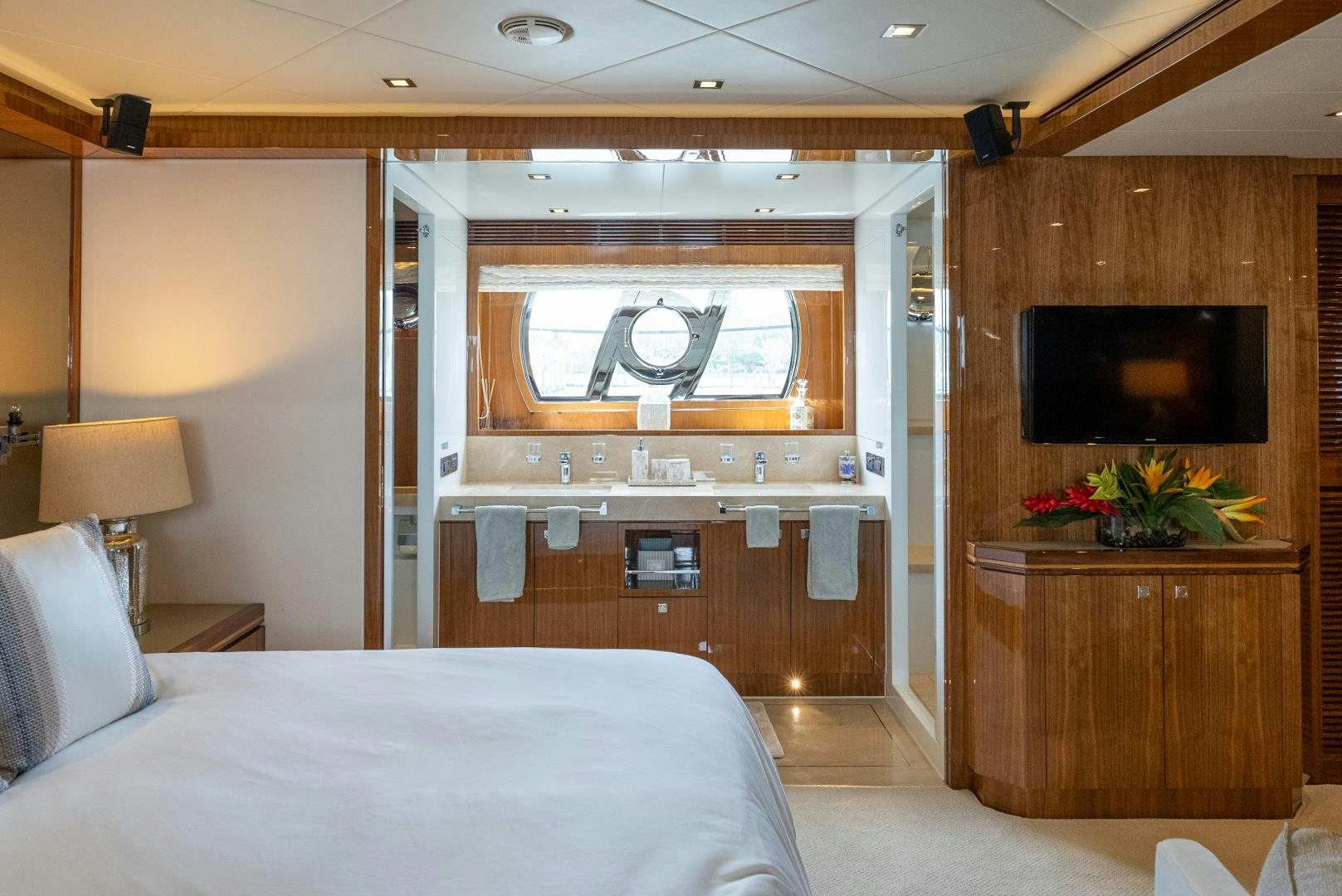 a room with a bed and a television aboard ENCORE Yacht for Sale