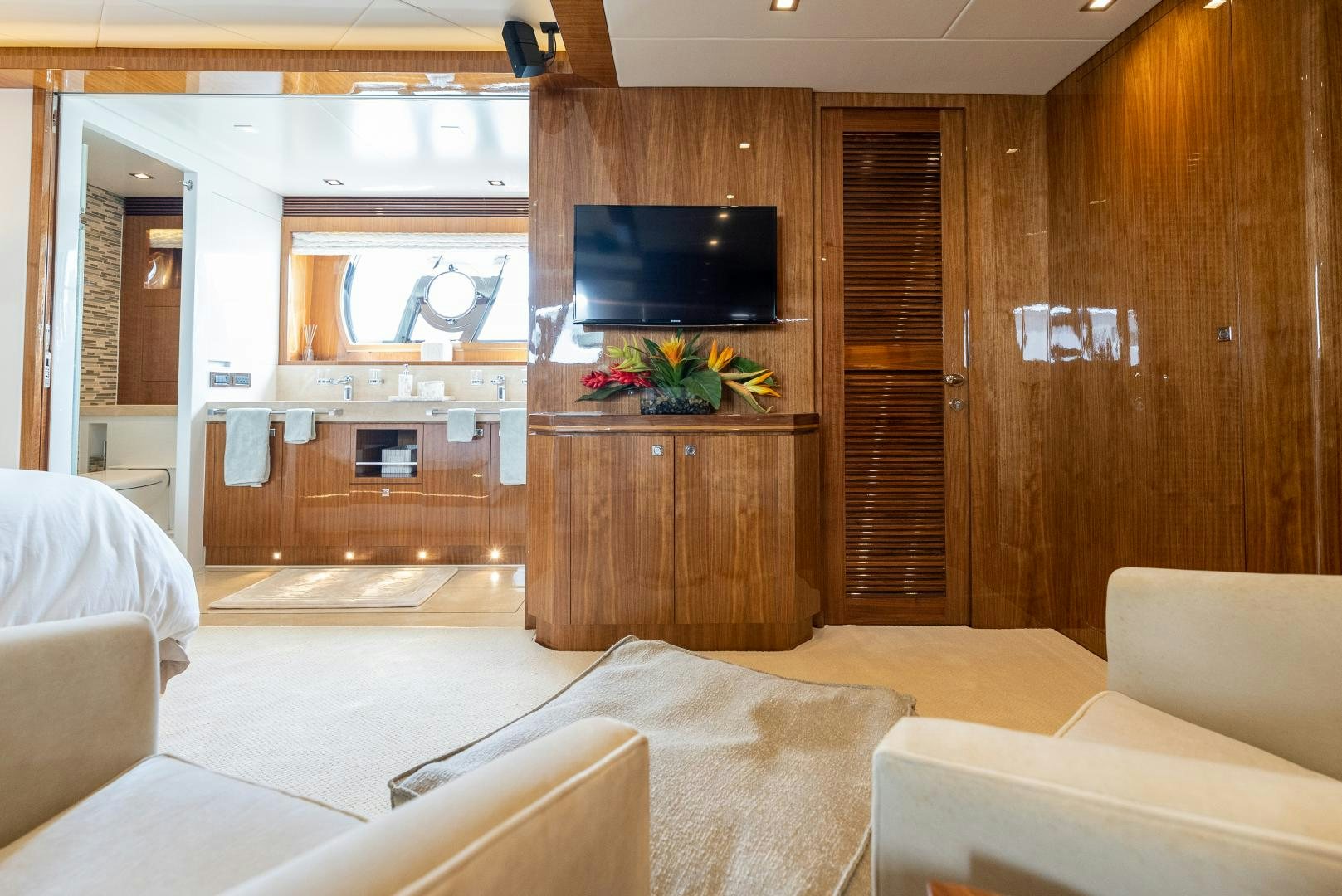 a room with a tv and furniture aboard ENCORE Yacht for Sale