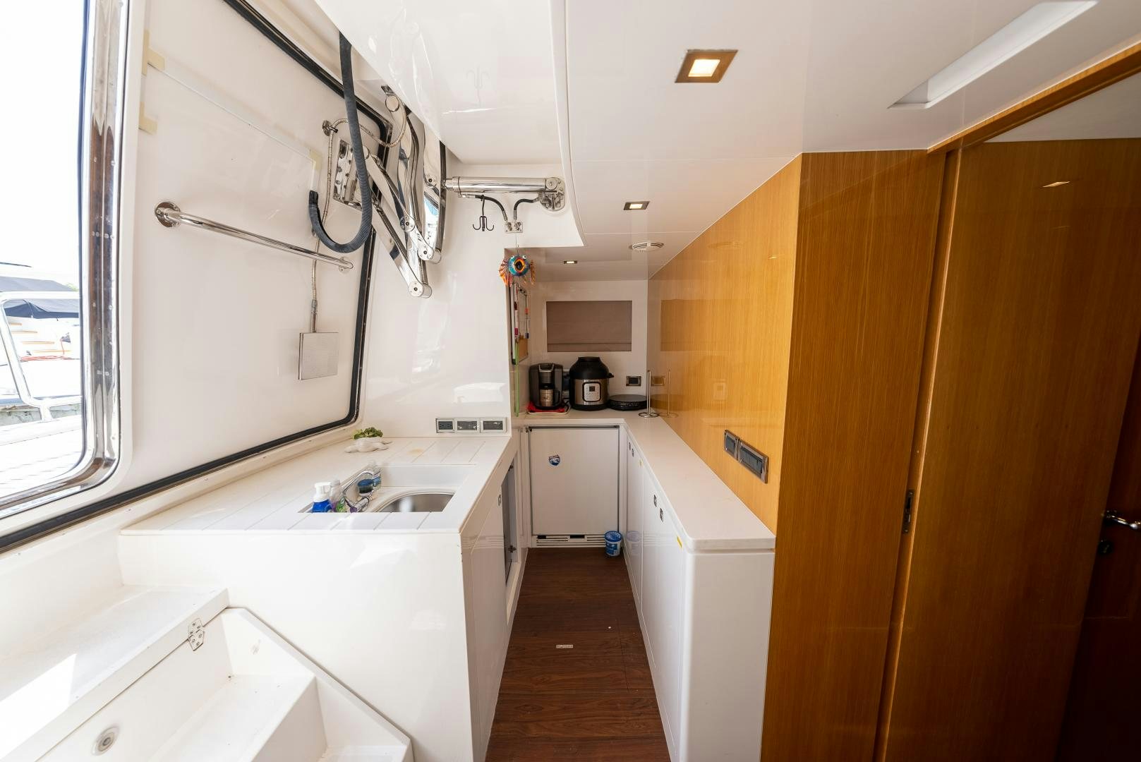 a kitchen with white cabinets aboard ENCORE Yacht for Sale