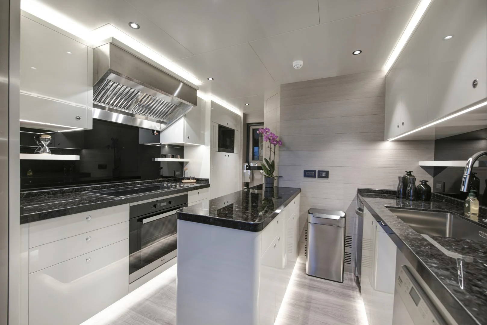 a kitchen with white cabinets aboard ALFRESCO 125 Yacht for Sale