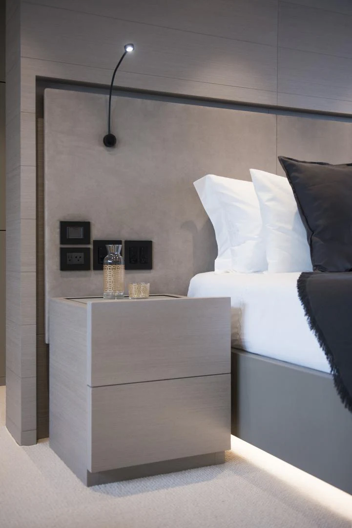 a white bed with a white bed and a white couch aboard ALFRESCO 125 Yacht for Sale