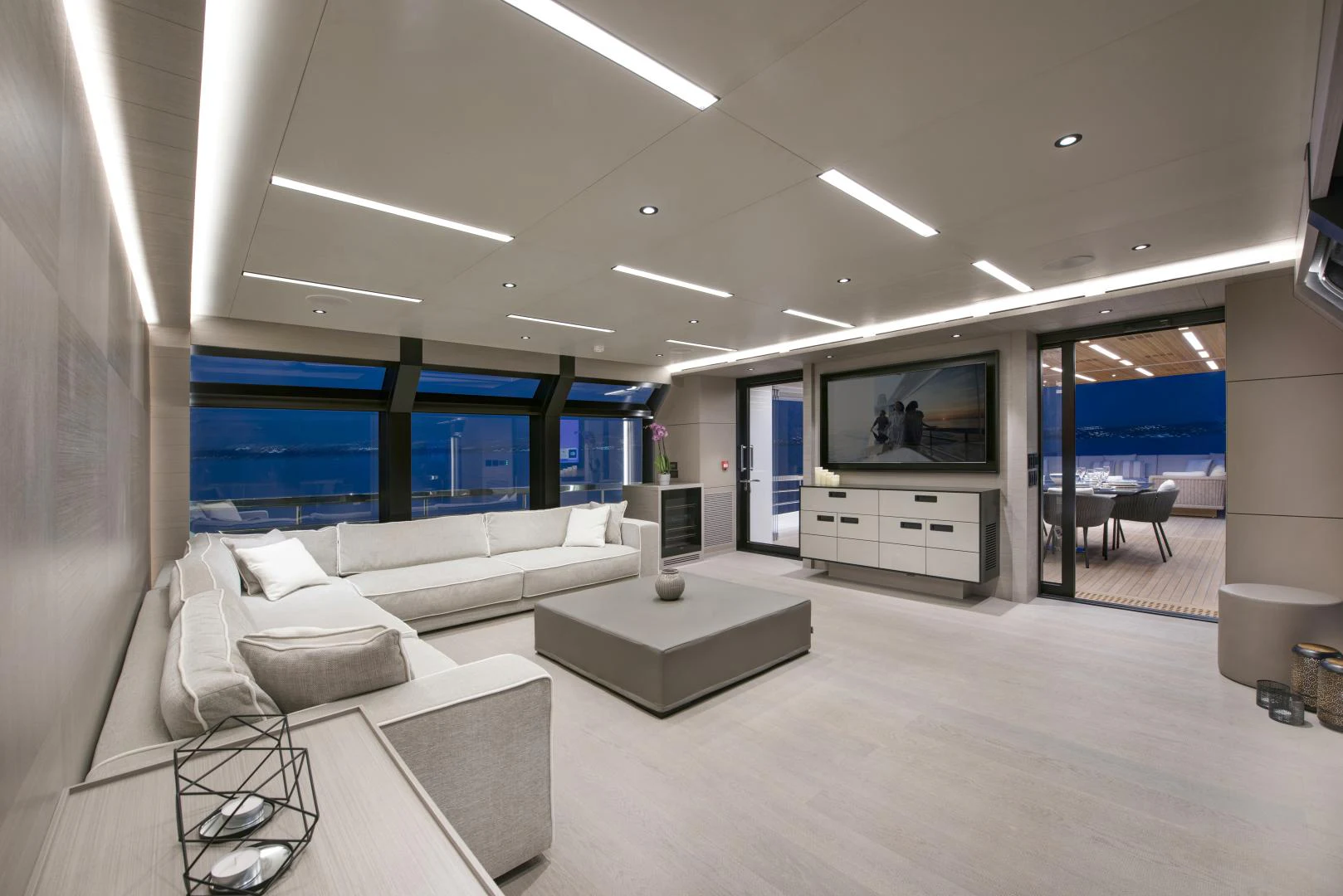 a room with white couches and a television aboard ALFRESCO 125 Yacht for Sale