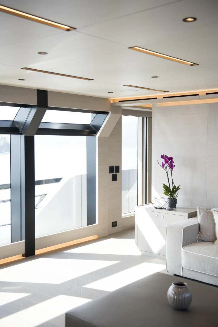 a room with a large glass door and a white sofa aboard ALFRESCO 125 Yacht for Sale