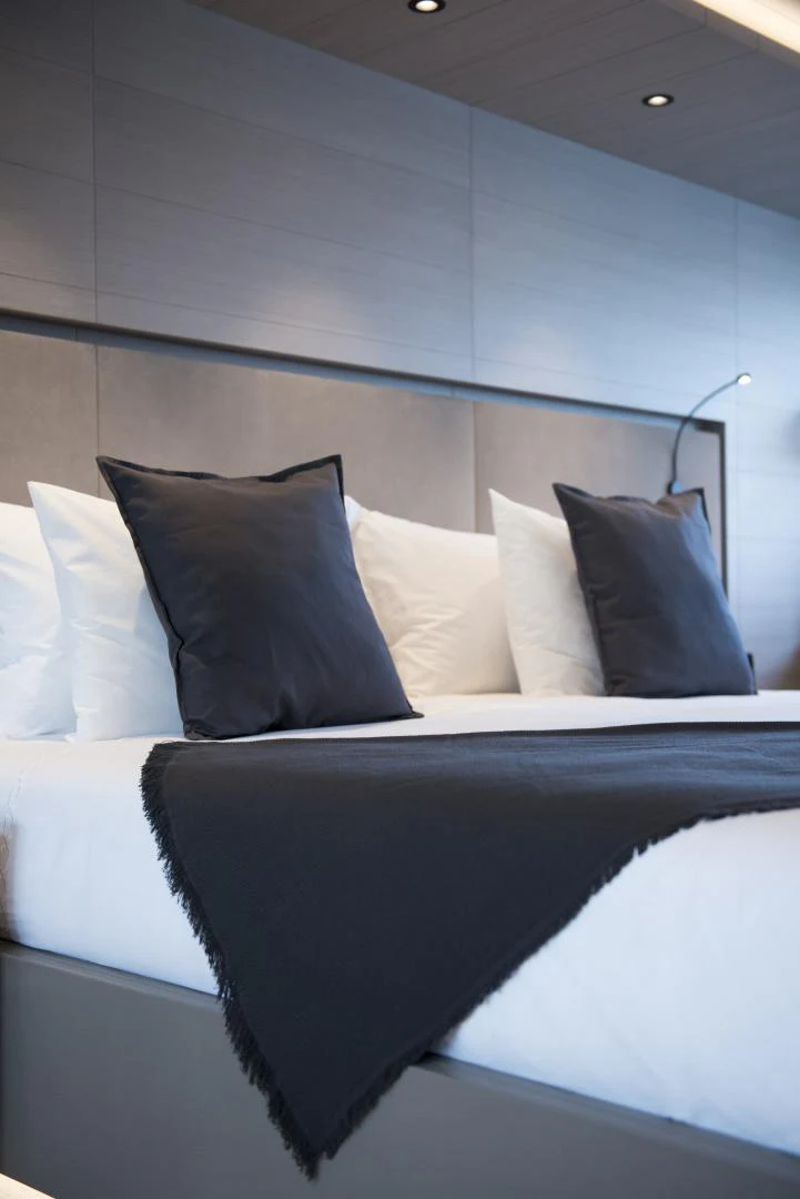 a bed with white sheets aboard ALFRESCO 125 Yacht for Sale
