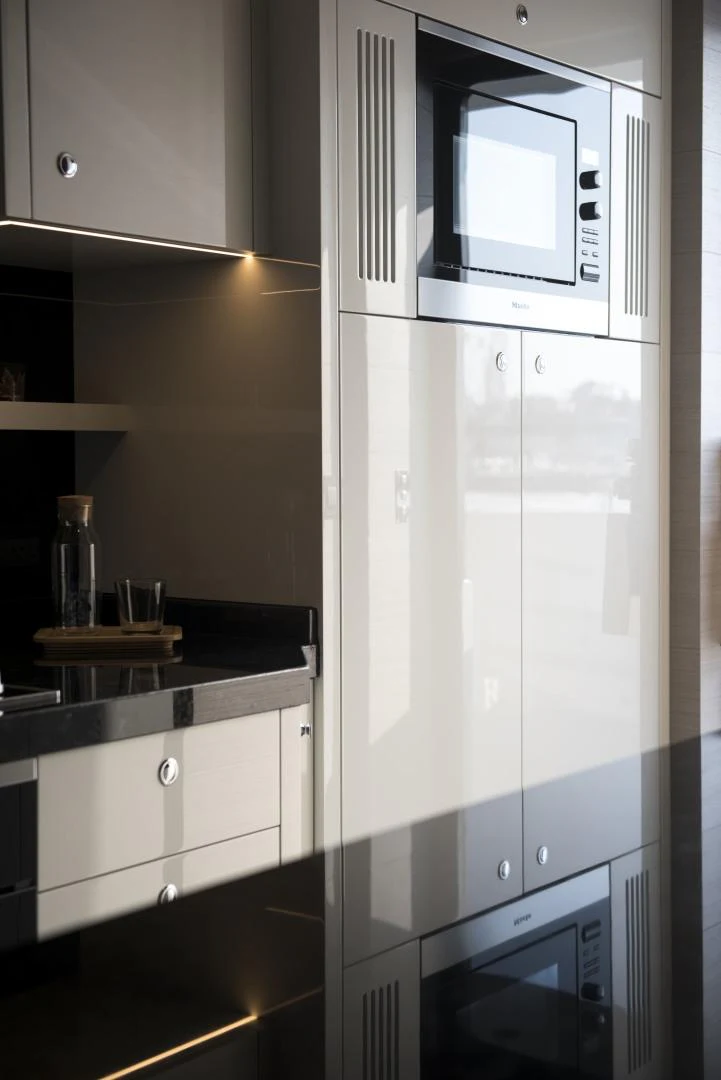 a white refrigerator in a kitchen aboard ALFRESCO 125 Yacht for Sale