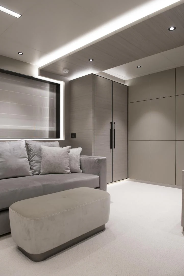 a white couch in a room aboard ALFRESCO 125 Yacht for Sale