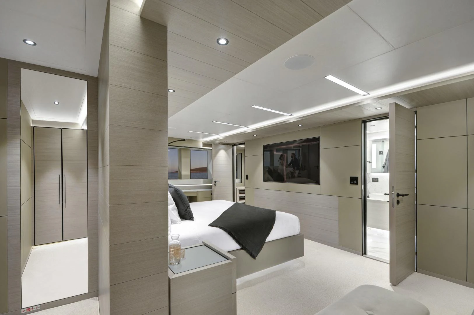 a room with a bed and a desk aboard ALFRESCO 125 Yacht for Sale
