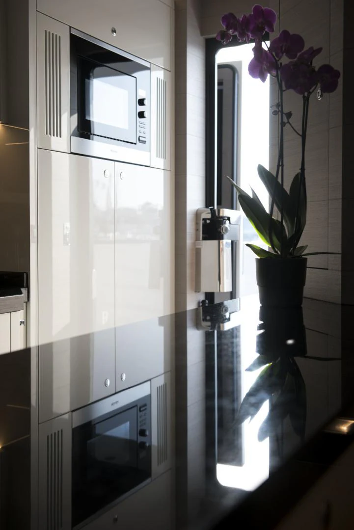a kitchen with a glass door aboard ALFRESCO 125 Yacht for Sale