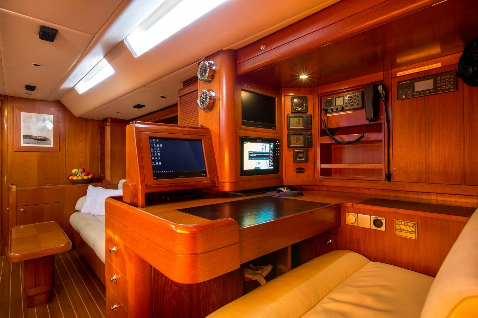 a room with a tv and a table aboard UMIKO Yacht for Sale