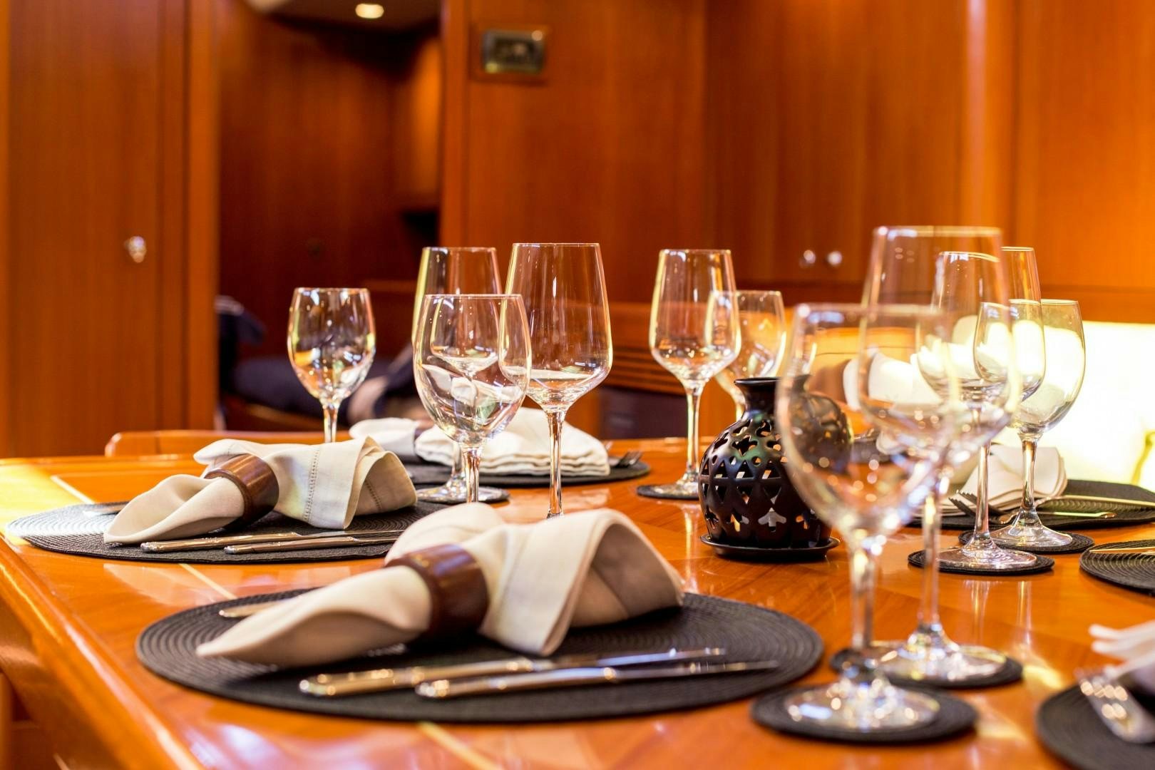 a table with wine glasses and food aboard UMIKO Yacht for Sale
