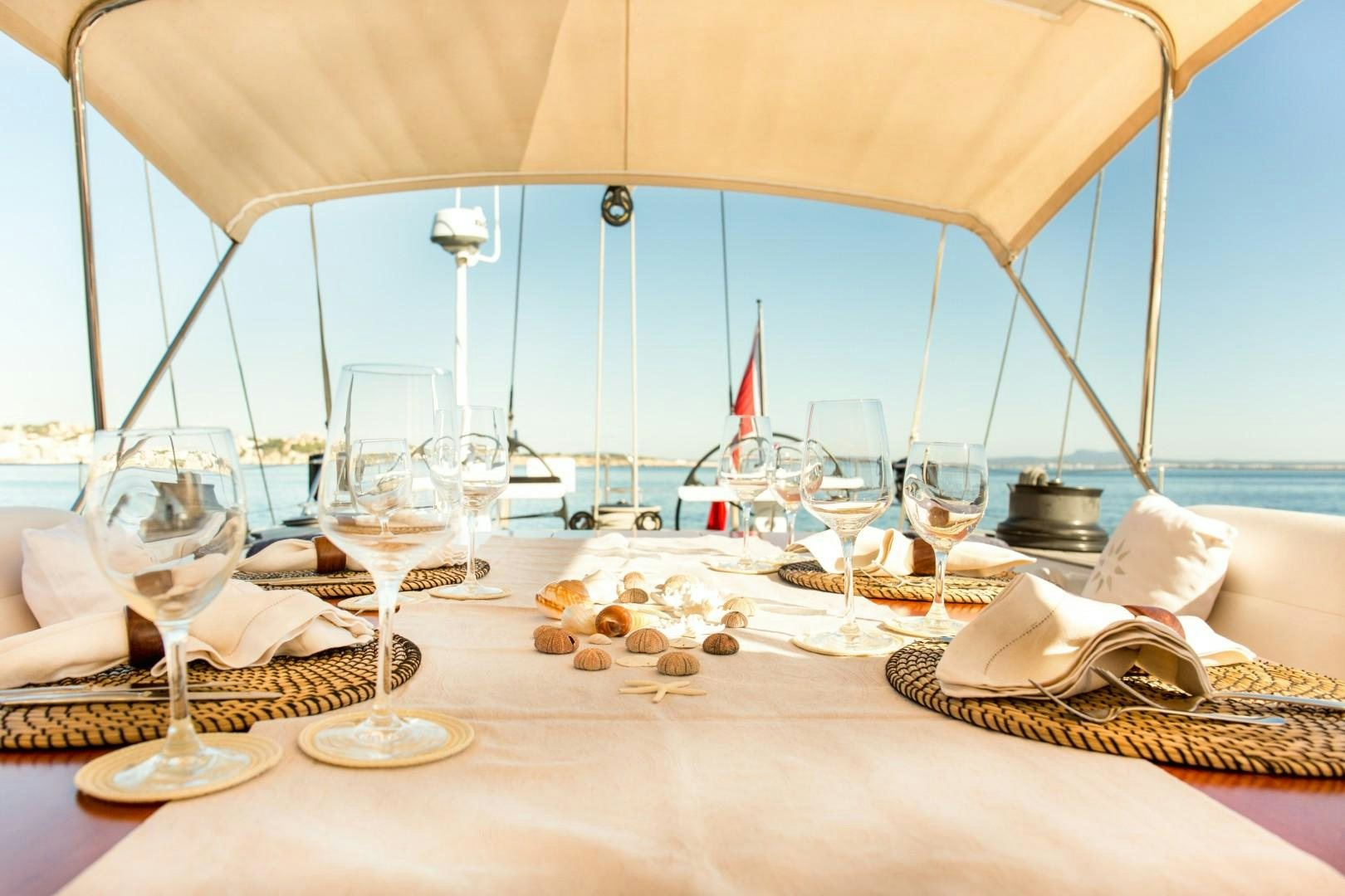 a table with wine glasses and food aboard UMIKO Yacht for Sale