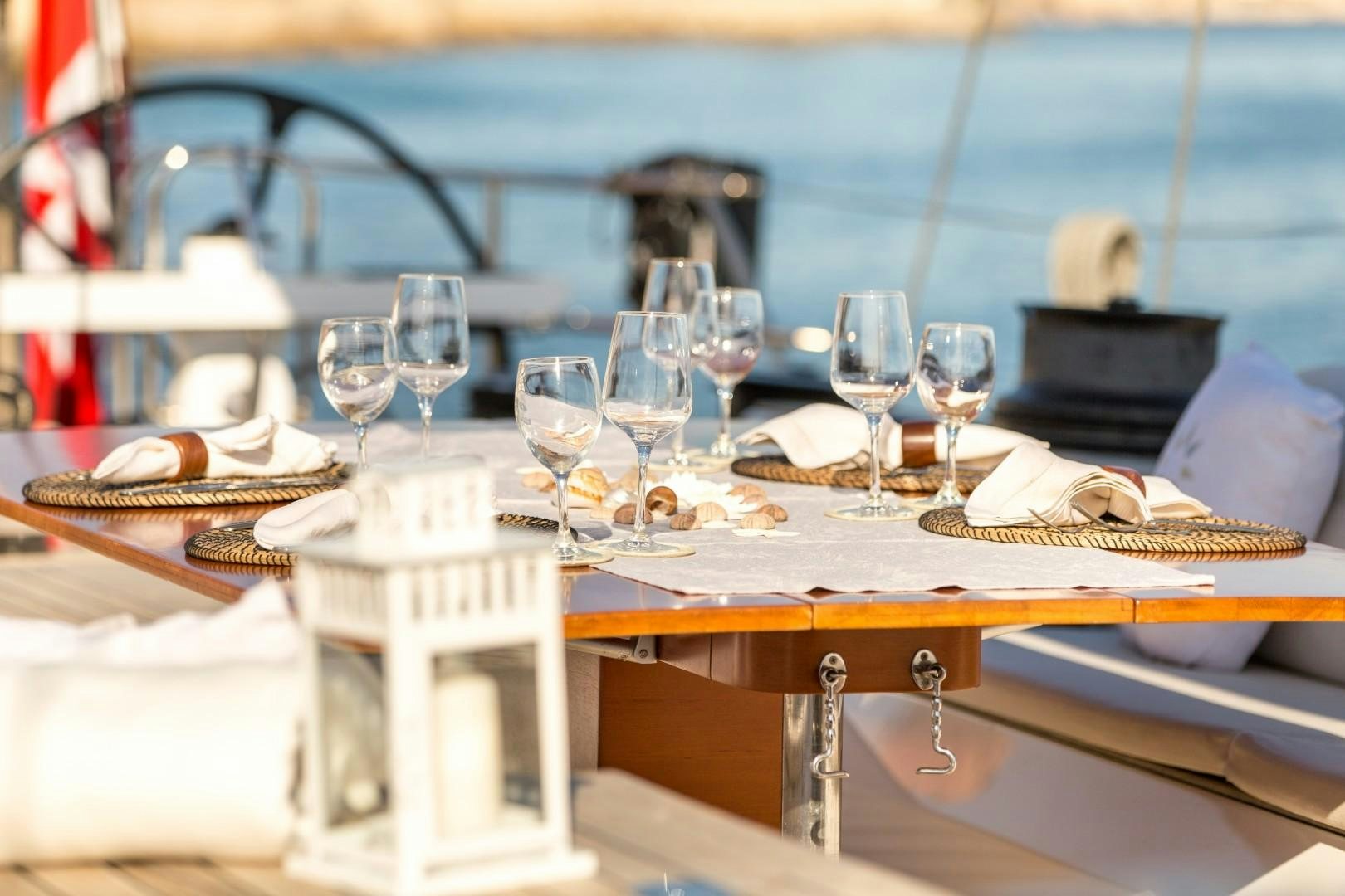 a table with wine glasses and food aboard UMIKO Yacht for Sale