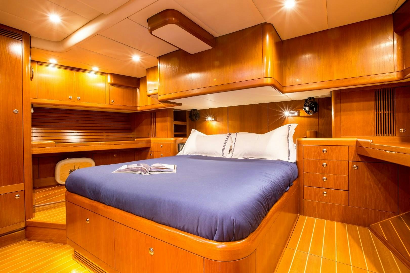 a large bed in a room aboard UMIKO Yacht for Sale