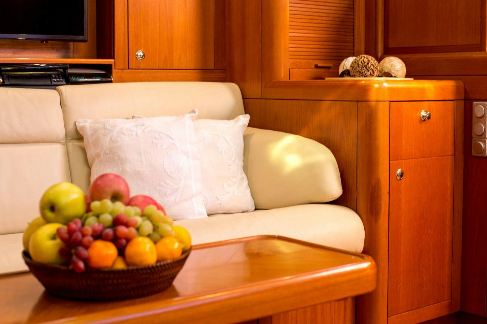 a bowl of fruit on a table aboard UMIKO Yacht for Sale